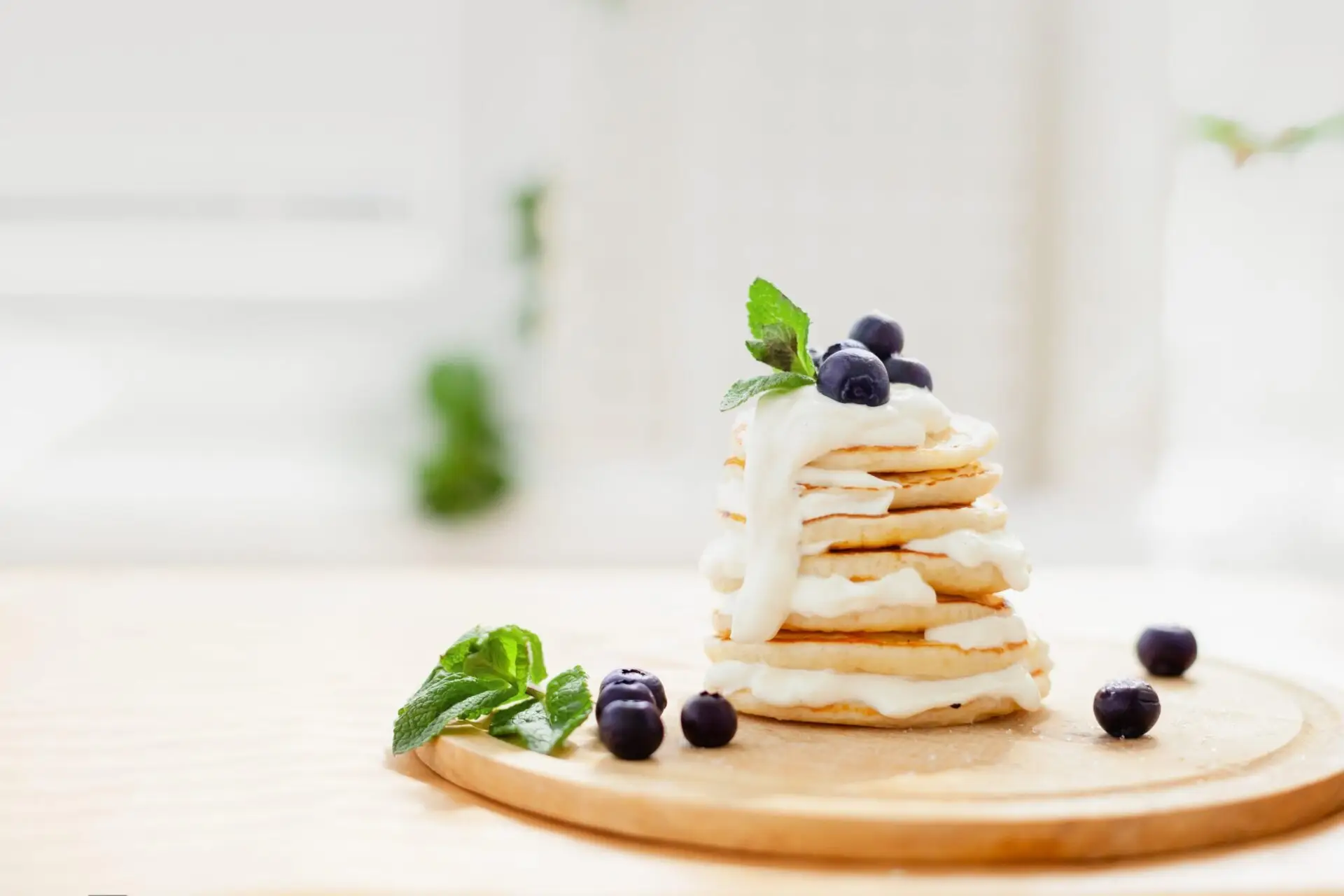 Pancakes,With,Sour,Cream,And,Blueberries,On,A,Light,Blurred